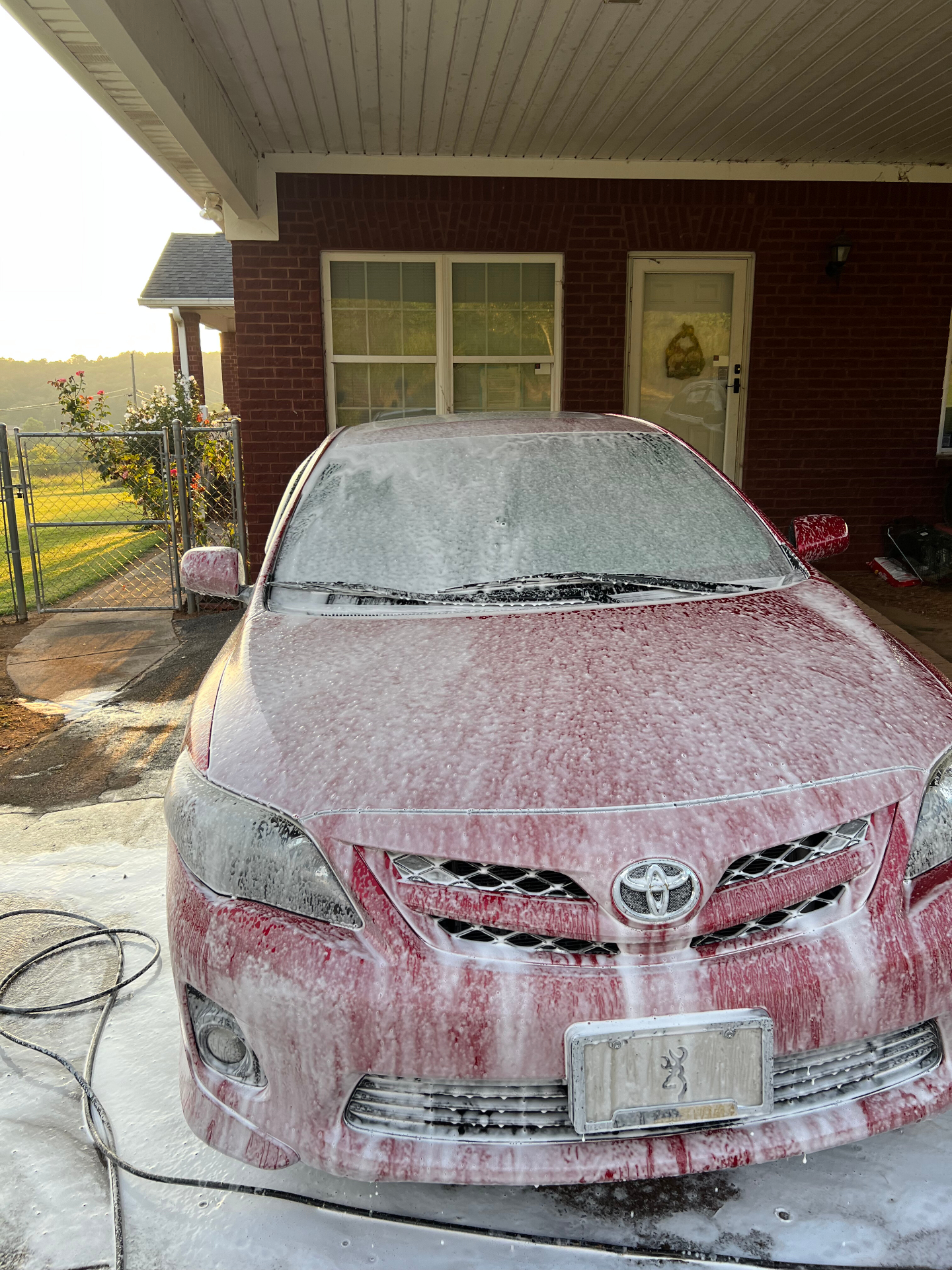 Toyota Corolla covered in thick foam during a hand wash